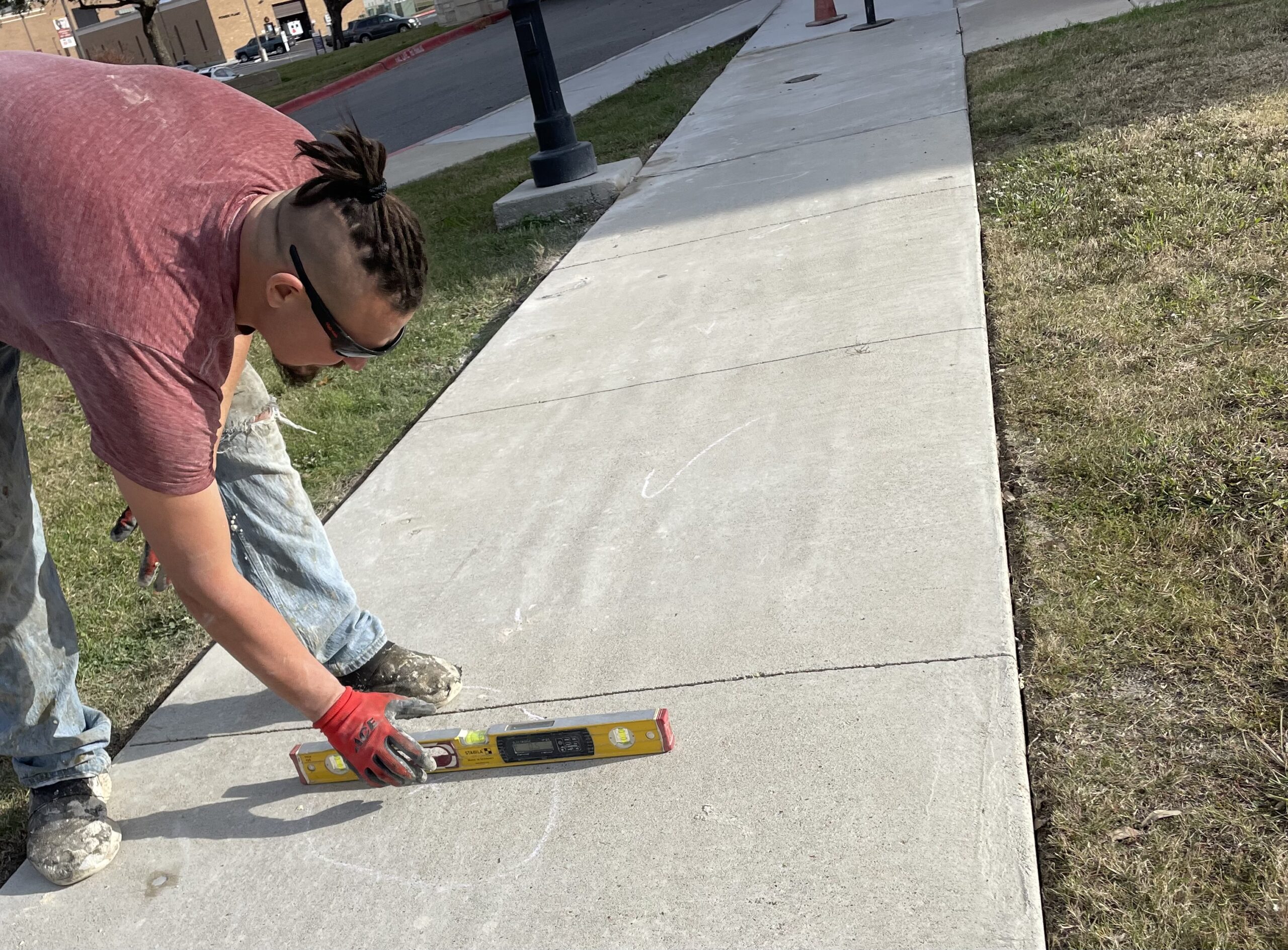 Precision Foundation Repair professional injecting foam beneath a residential sidewalk to level a sunken slab in Stephenville, Texas. Precision Foundation Repair professional injecting foam beneath a residential sidewalk to level a sunken slab in Stephenville, Texas.