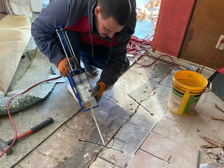 Polyurethane foam being injected for foundation stabilization beneath a house foundation in Mineral Wells, Palo Pinto County, Texas.