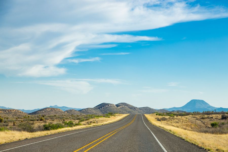 A Precision Foundation Repair crew member surveying a foundation issue on a commercial building in Mineral Wells, Palo Pinto County, Texas.