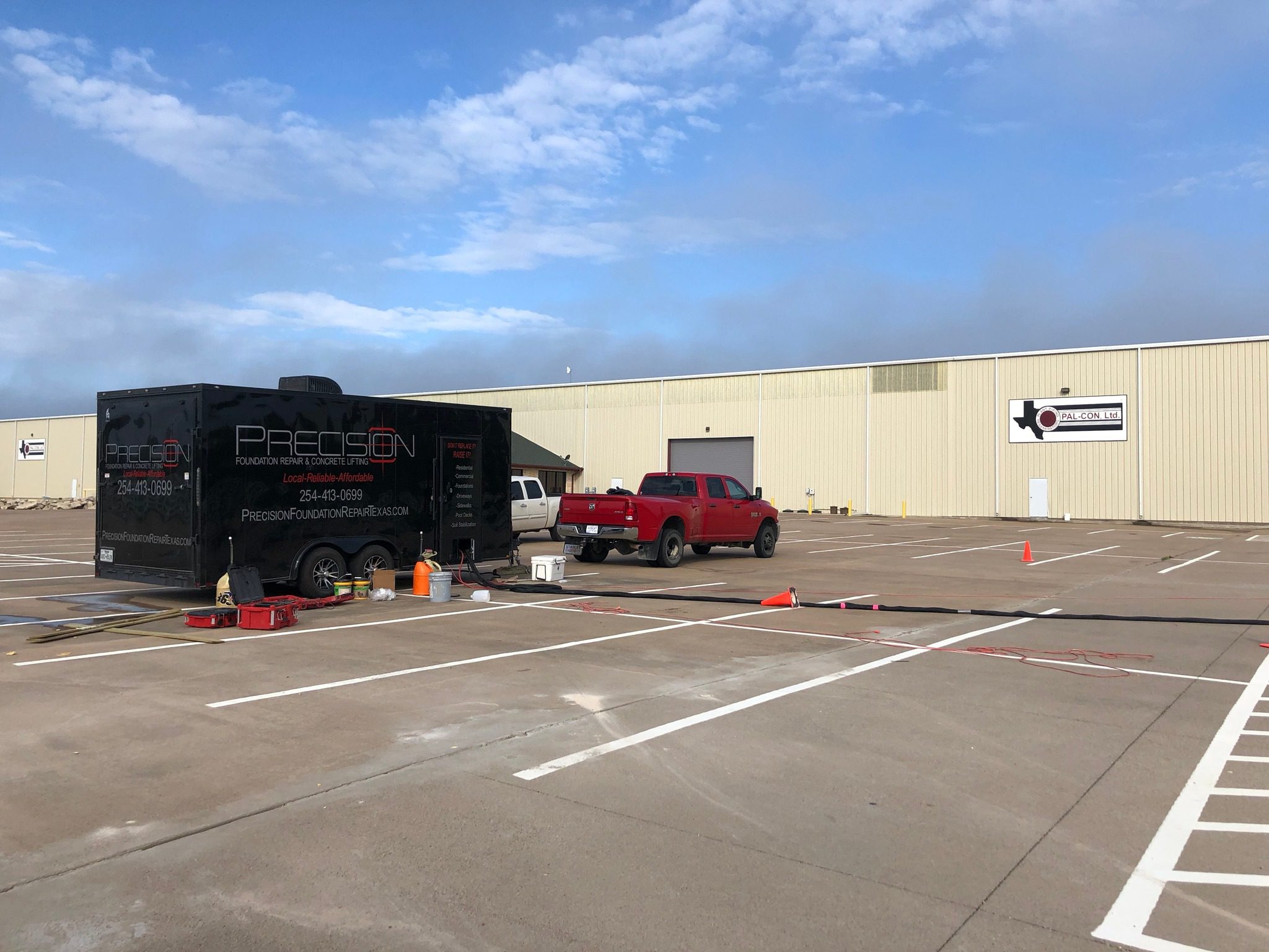 Precision Foundation Repair technicians performing an inspection on a business foundation in Azle, Texas.